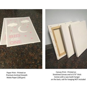 May include: Two prints: one paper print and one canvas print. The paper print has a grey background with a crescent moon, stars, and the text "dream BIG little ONE" in pink. The canvas print is stretched and is 1.9 cm thick.
