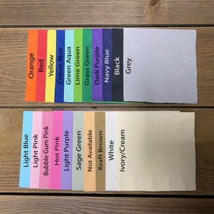 May include: A color chart of paper samples for crafting and scrapbooking. The colors include orange, red, yellow, cobalt blue, green aqua, lime green, grass green, dark purple, navy blue, black, grey, light blue, light pink, bubble gum pink, hot pink, light purple, sage green, not available, kraft brown, white, and ivory/cream.