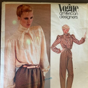 May include: A vintage sewing pattern from Vogue American Designers for a blouse and trousers by Anne Klein. The pattern number is 2611.