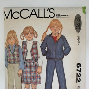 May include: A sewing pattern for a girl's outfit. The pattern includes a plaid skirt, a vest, and a striped pantsuit. The pattern is from McCall's and is size 6. The pattern is $2.20.