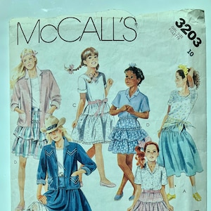 May include: McCall's sewing pattern for girls' skirts, pattern number 3203, size 10. The pattern includes five different skirt styles, including a denim skirt with a lace trim, a plaid skirt, and a tiered skirt.