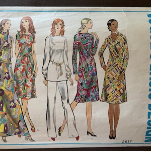 May include: Vintage Vogue's Basic Design sewing pattern showing five women's fashion designs. The designs include dresses and a trouser suit, with colourful patterns and a retro aesthetic. The pattern number is 2617.