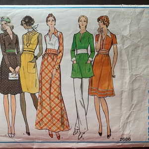 May include: A vintage sewing pattern featuring five different dress designs. The pattern is titled "Vogue's Basic Design" and has the number 2686 printed on it.