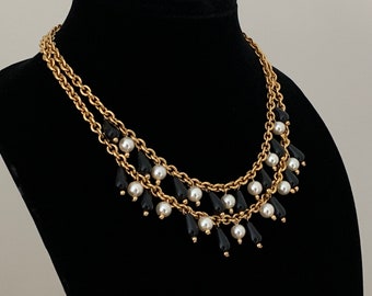 Vintage 1990s Dramatic Gold Tone Metal Necklace. Two Gold Tone Metal Chains with Round Faux Pearl and Black Teardrop Beads. Great Condition.