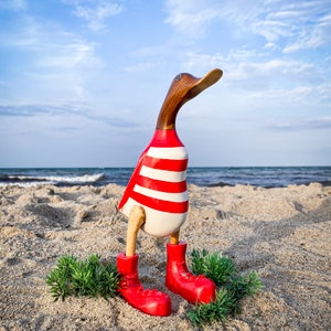 Walked naturally with red boots and red and white striped shirt about 35 cm high