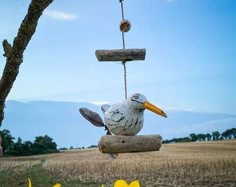 Wind chime 1 seagull with propeller on driftwood.