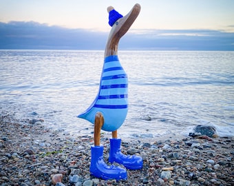 Running with blue boots, blue-light blue striped shirt and poodle cap about 35 cm high