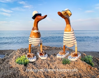 Running duck with hat and flip flops in a white and blue striped swimsuit 25 cm high