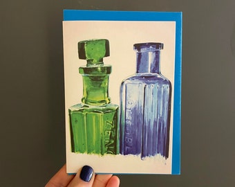 Carte de voeux de bouteilles vertes et bleues