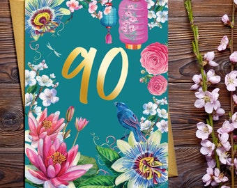 Carte d'anniversaire 90 ans avec éléments décoratifs floraux et caractères dorés