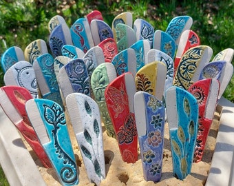 May include: A collection of colorful ceramic tiles with floral and geometric patterns. The tiles are arranged in a fan shape and have a variety of blue, red, green, and yellow hues.