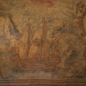 May include: A vintage-style map with a hand-painted image of a ship sailing on the ocean. The map is faded and worn, giving it a rustic look. The ship is detailed with sails and rigging, and the ocean is depicted in shades of blue and green.