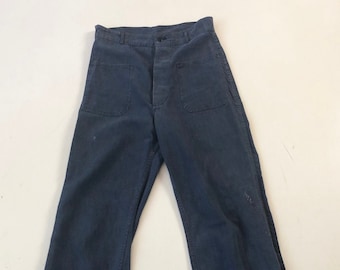 May include: A pair of dark blue work pants with a button fly and large pockets.