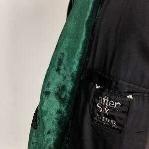 May include: A dark green velvet jacket with a black lining. The jacket has a pocket on the left side with a black and white label that reads "after six by rudofker masters youngstown, ohio".