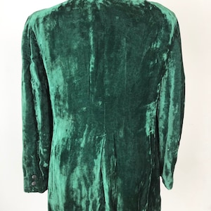 May include: A dark green velvet blazer with a black collar. The blazer has a classic cut and is made of a soft, luxurious fabric.