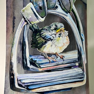 May include: A watercolor painting of a small bird perched on a silver stirrup. The bird is yellow, green, and blue with a yellow beak. The stirrup is hanging from a leather strap.
