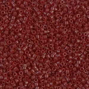May include: A close-up view of a large quantity of small, round, red beads. The beads are opaque and have a slightly glossy finish.