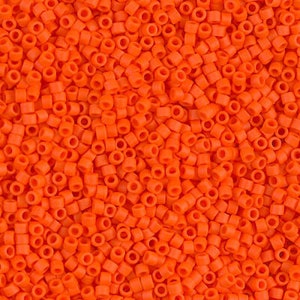 May include: A close-up image of a large quantity of small, bright orange round seed beads. The beads are all the same size and shape, and they are arranged in a random pattern.
