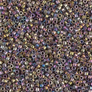 May include: A close-up image of a large quantity of small, round, iridescent beads. The beads are a mix of gold, purple, and blue colors.