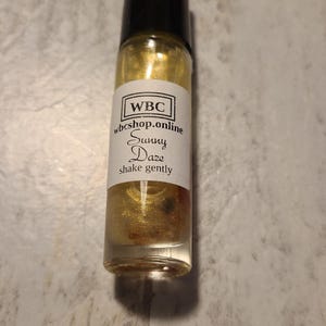 Sunny Daze tropical flower scented crystal infused essential oil roller.