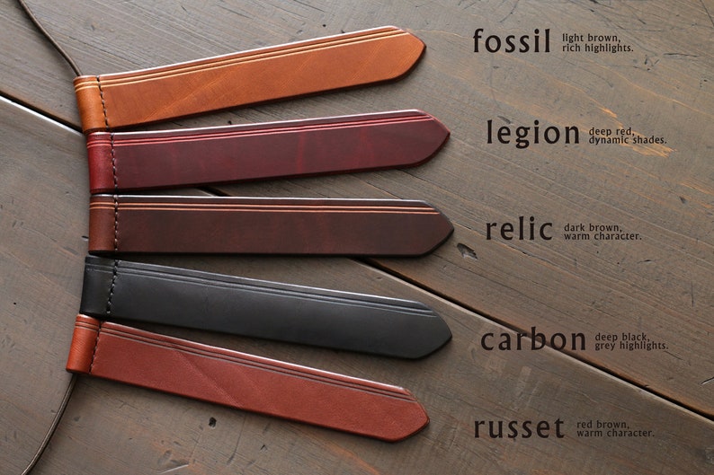 May include: Five leather straps in different colors and textures, labeled with names and descriptions. The colors are: fossil (light brown), legion (deep red), relic (dark brown), carbon (deep black), and russet (red brown).