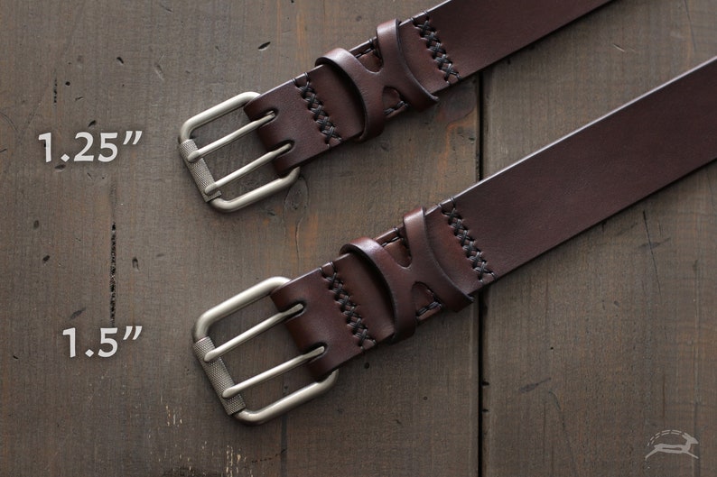 May include: Two brown leather belts with silver double prong buckles. The belt on the top has a 1.25 inch width and the belt on the bottom has a 1.5 inch width.
