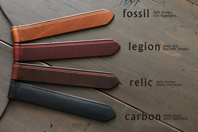 May include: Four leather watch straps in shades of brown, red, dark brown, and black, each with a contrasting stripe and stitching. The text on the image reads "fossil", "legion", "relic", and "carbon".