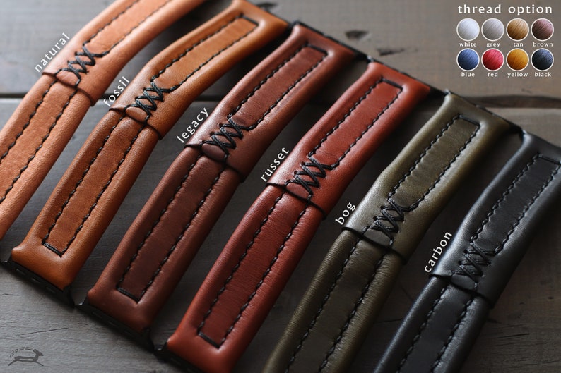 May include: Close-up of six leather watch straps in different colors and textures, including natural, fossil, legacy, russet, bog, and carbon. Each strap has a contrasting thread color and a stitched design. The text "thread option" is displayed above a color chart with the thread colors: white, grey, tan, brown, blue, red, yellow, and black.