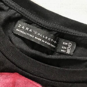May include: Close-up of a black t-shirt with a label that reads "ZARA COLLECTION" and "RN(USA)77302 MADE IN PORTUGAL." The label also indicates size "L" for EUR and USA, and "30" for MEX.