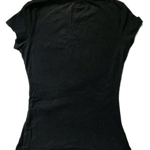 May include: A black, short-sleeved t-shirt with a scoop neck. The shirt is made of a soft, slightly textured fabric. The t-shirt is a solid black color and is likely made of cotton or a cotton blend.