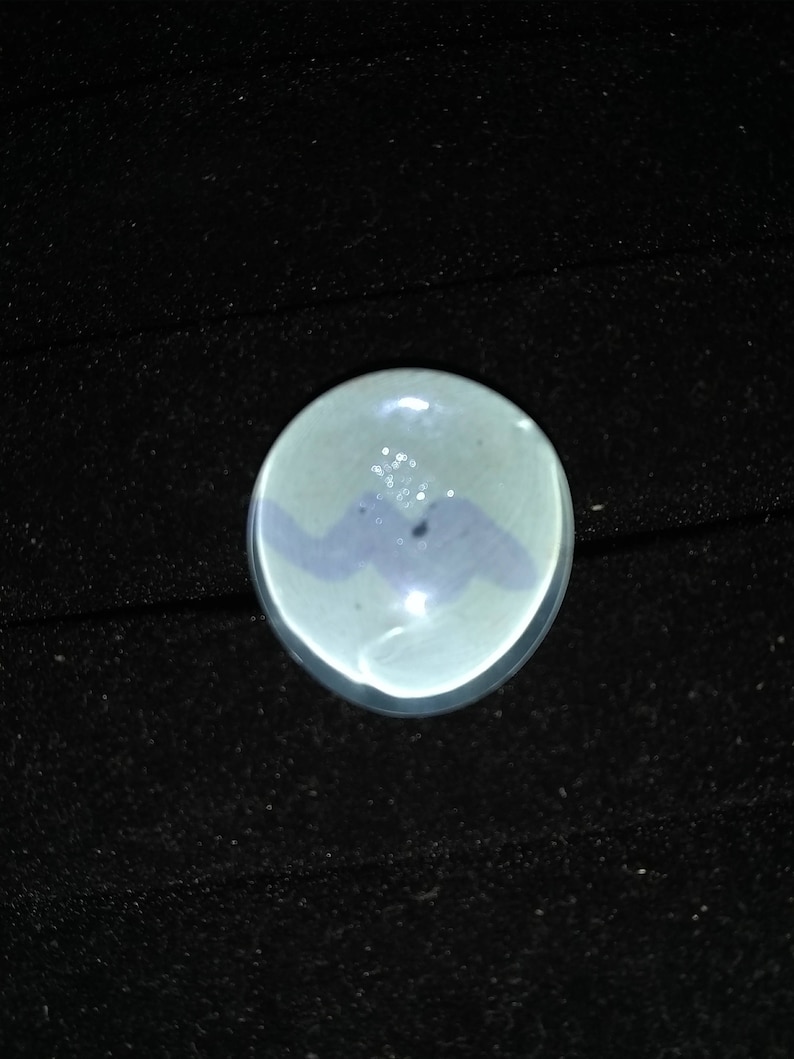 May include: A small, round, white ceramic dish with a blue and white design. The dish has a glossy finish and is perfect for serving small snacks or appetizers.