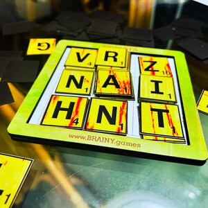 May include: A yellow and red game board with letter tiles that spell out "VRZAINT" and the website "www.BRAINY.games".