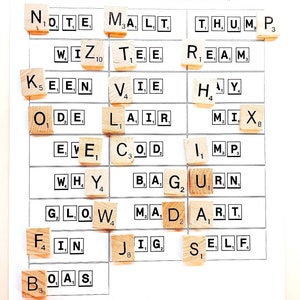 May include: A Scrabble game board with letter tiles arranged to spell out words like "Note", "Malt", "Thumb", "Wiz", "Tee", "Keen", "Vie", "Ode", "Lair", "Reams", "Hay", "Mix", "Eve", "Cod", "Imp", "Why", "Bag", "Urn", "Glow", "Mad", "Art", "Fin", "Jig", and "Self".