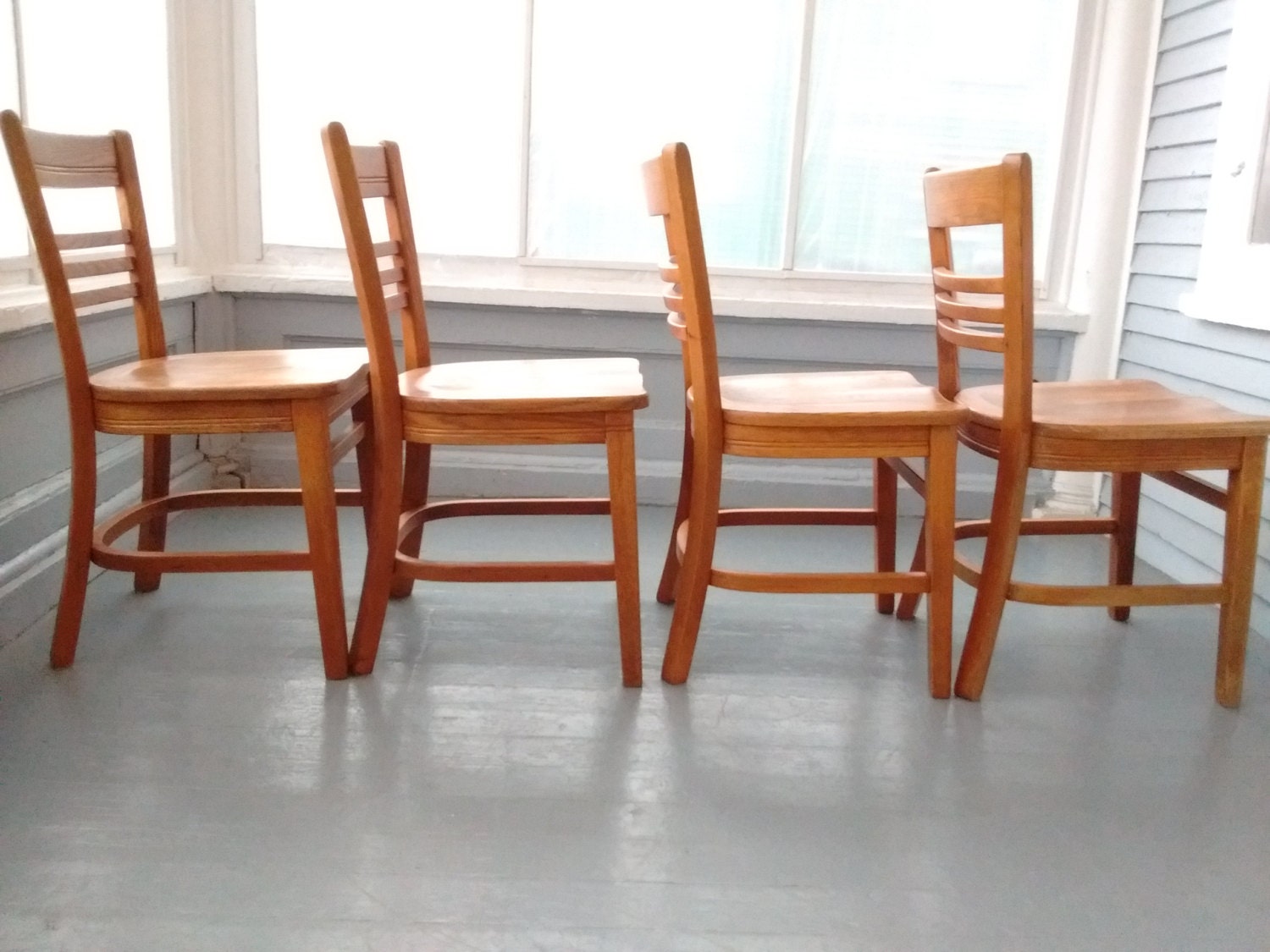 four wooden dining room chairs
