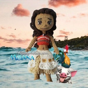 May include: Crocheted Moana doll with brown hair, a red and white top, and a white skirt. She is standing with a rooster and a pig.