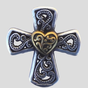 May include: Silver cross pendant with a gold heart in the center. The cross and heart have intricate floral designs.