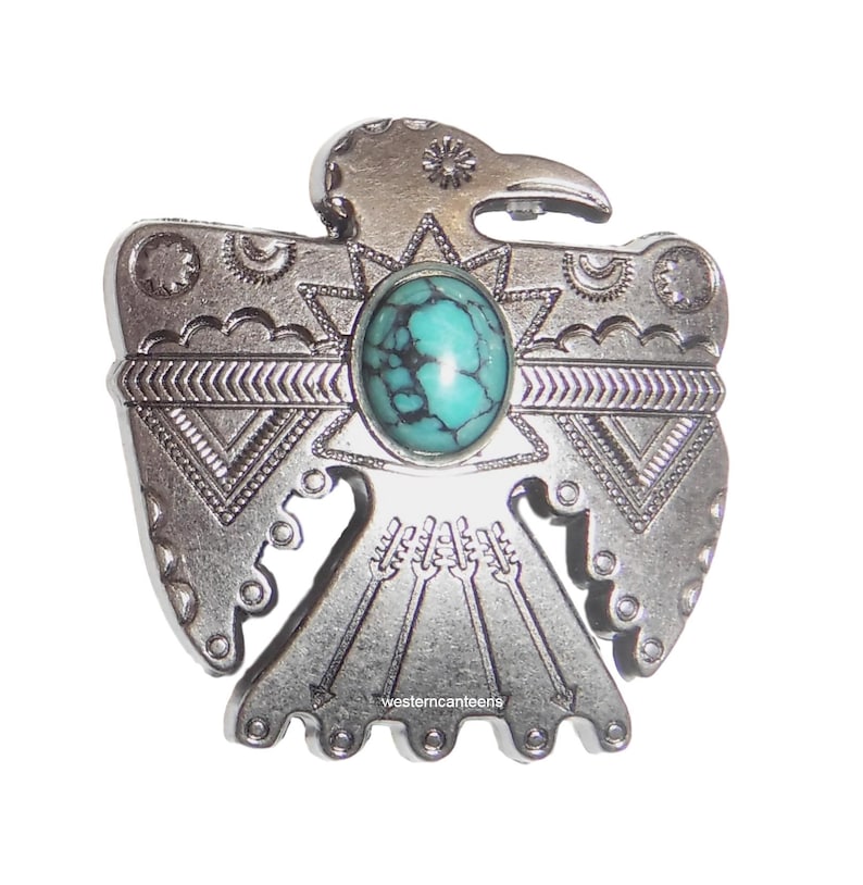 May include: Silver-toned metal pendant featuring a stylized Native American Thunderbird design with a turquoise stone in the center. The pendant has intricate details and a western canteen logo.