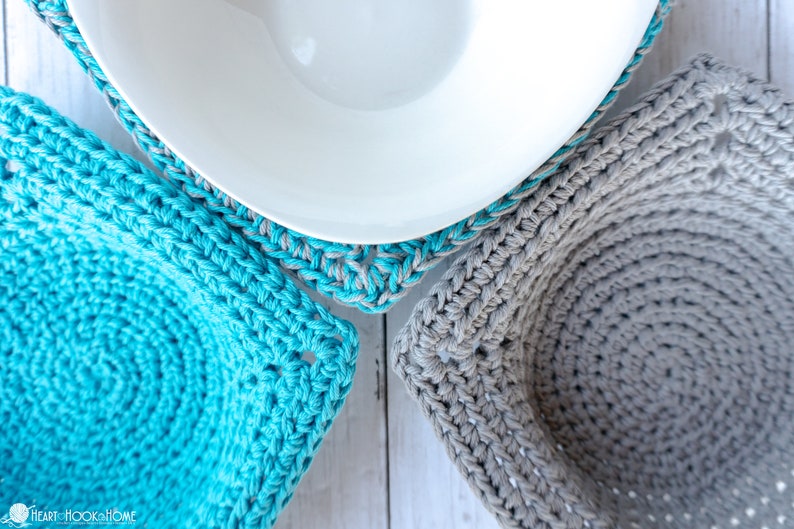 May include: Three crocheted bowl cozies in different colors and patterns. One is gray, one is turquoise, and one is a turquoise and gray combination.