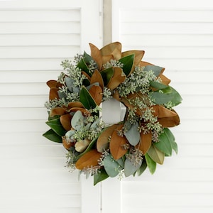 May include: A brown and green magnolia leaf wreath with eucalyptus sprigs.