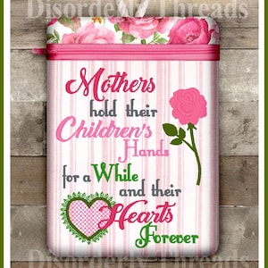 May include: Pink and green zippered pouch with a white background and pink stripes. The pouch has a floral design at the top and the text "Mothers hold their Children's Hands for a While and their Hearts Forever".