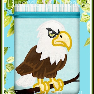 May include: A blue zippered pouch with a white and brown embroidered bald eagle perched on a branch. The eagle has a yellow beak and green eyes. The pouch has the text "Disorderly Threads" printed on the bottom.