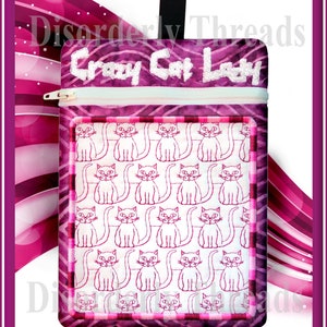 May include: A pink and white zippered pouch with a "Crazy Cat Lady" design. The pouch features a repeating pattern of white cats with pink outlines on a white background.