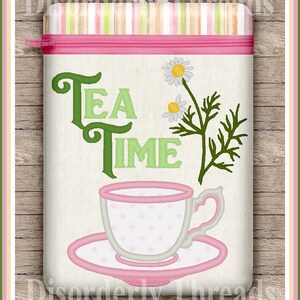 May include: A white canvas zippered pouch with pink trim and a pink zipper. The pouch has green embroidered text that says "Tea Time" and a green embroidered daisy with a pink cup and saucer.