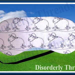 May include: White sleep mask with a black elastic strap. The mask has a repeating pattern of black and white sheep.