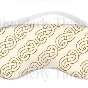 May include: A white sleep mask with a repeating pattern of gold infinity knots. The mask has an elastic band for a comfortable fit.