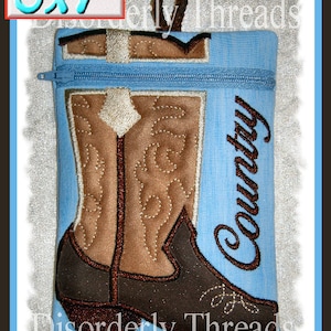 May include: A blue zippered pouch with a brown cowboy boot design and the word "Country" embroidered on it. The pouch measures 5x7 inches.