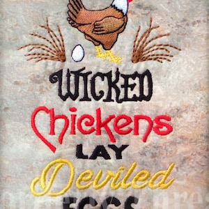 May include: Embroidered design on a beige fabric background featuring a red, brown, and white chicken with a yellow beak and legs. The text reads "Wicked Chickens Lay Deviled Eggs".