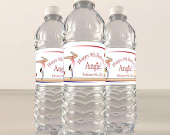 May include: Three clear plastic water bottles with personalized labels. Each label features a red, white, and blue design with a gymnast performing a handstand on a balance beam. The text on the label reads "Happy 9th Birthday Angie! February 9th, 2024".