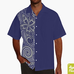 May include: A navy blue short-sleeved button-up shirt with a gray and white Polynesian-inspired design on the left side.