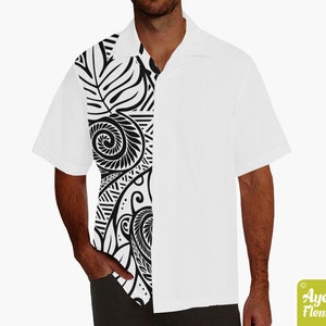 May include: White short-sleeved button-up shirt with a black and white Polynesian-style design on the left side. The design features intricate swirls and patterns.